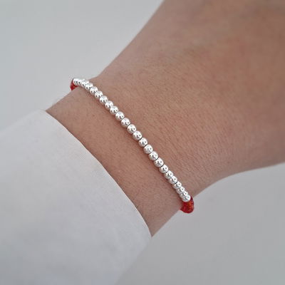 Pulsera bolitas cristal rojo - Ac. Blanco