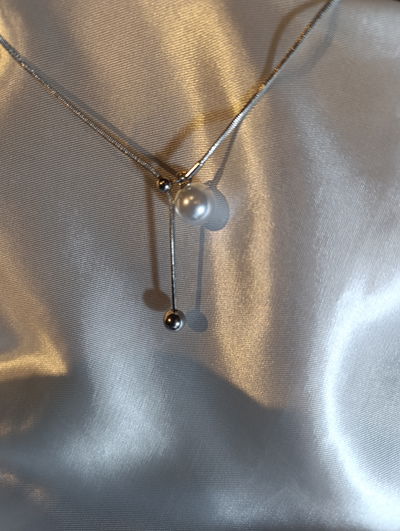 Collar acero quirúrgico cilindrico con perla regulable 
