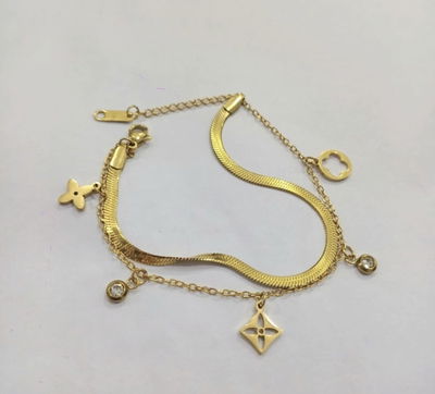 Pulsera de acero quirurgico con dijes de nudo de bruja y stras