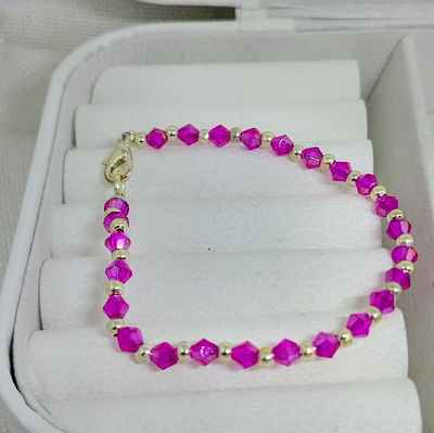 Pulsera cristales fucsia y bolitas acero blanco