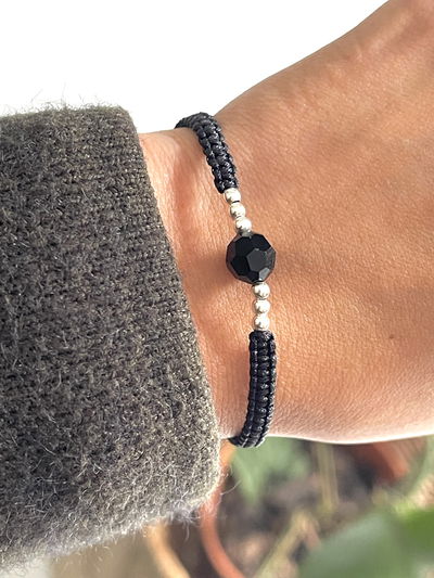 Pulsera de hilo negro con cristal negro y bolitas de plata 