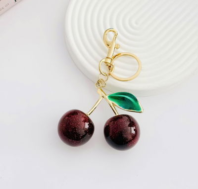 Llavero Bag Charms cerezas bordo y hoja verde 
