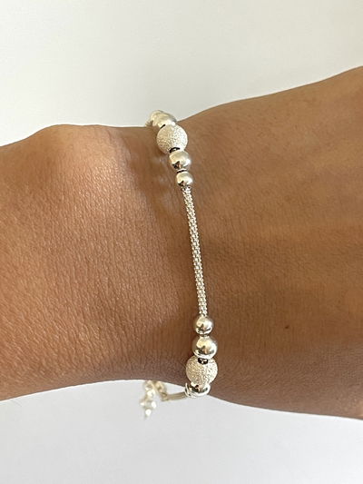 Pulsera con bolitas dispersas .