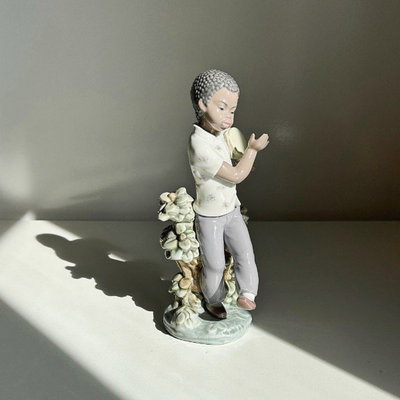 Lladro niño cubano con bango y detalle floral