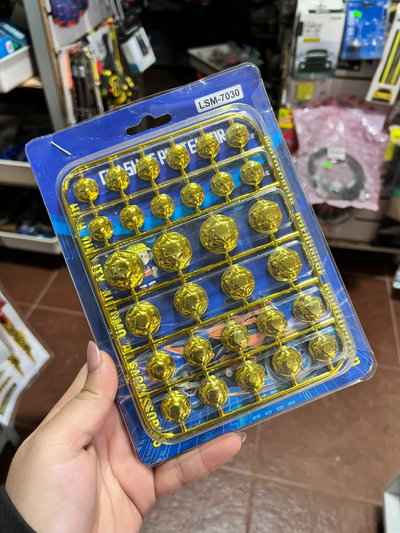 Cubre tornillos con diseño dorado